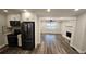 Open concept kitchen with stainless steel appliances and hardwood floors that transitions into the living room at 695 Pine Shadows Dr, Dallas, GA 30157