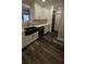 Bright kitchen with black sink, stainless steel appliances and hardwood floors at 695 Pine Shadows Dr, Dallas, GA 30157