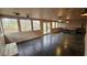 Bright sunroom with multiple windows, a hot tub, and wood paneled walls at 695 Pine Shadows Dr, Dallas, GA 30157