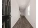 Modern hallway with dark hardwood floors, leading to the front door at 12093 Conrad Circle, Hampton, GA 30228
