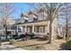 Attractive two-story home featuring a covered porch with decorative columns and a well manicured lawn at 2165 Parkview Nw Run, Atlanta, GA 30318