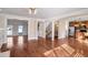 Open-concept living space with hardwood floors, leading to the kitchen and staircase at 2165 Parkview Nw Run, Atlanta, GA 30318