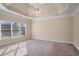 Bright primary bedroom showcasing tray ceilings, large windows, and ample space at 2165 Parkview Nw Run, Atlanta, GA 30318