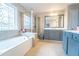 Well-lit bathroom featuring a large tub, glass enclosed shower, and a beautiful stained glass window at 4621 Wehunt Commons Se Dr # 7, Smyrna, GA 30082