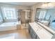 Luxurious bathroom featuring a soaking tub, glass shower, and dual sinks for ultimate relaxation at 4621 Wehunt Commons Se Dr # 7, Smyrna, GA 30082