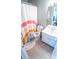 Small bathroom with tile floors, neutral walls, shower with rainbow curtain, and white vanity at 4621 Wehunt Commons Se Dr # 7, Smyrna, GA 30082