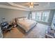 Spacious bedroom with tray ceiling, ceiling fan, gray walls, and abundant natural light at 4621 Wehunt Commons Se Dr # 7, Smyrna, GA 30082