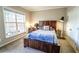 Comfortable bedroom features a wood bed frame, a desk, and neutral décor at 4621 Wehunt Commons Se Dr # 7, Smyrna, GA 30082