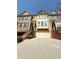 Traditional brick townhouse with a two-car garage and manicured landscaping at 4621 Wehunt Commons Se Dr # 7, Smyrna, GA 30082