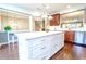 Bright eat-in kitchen boasts wooden floors, stainless steel appliances, and a large center island with white countertops at 4621 Wehunt Commons Se Dr # 7, Smyrna, GA 30082