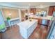 Bright eat-in kitchen boasts wooden floors, stainless steel appliances, and a large center island with white countertops at 4621 Wehunt Commons Se Dr # 7, Smyrna, GA 30082