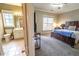 Comfortable bedroom featuring a rustic wood bed frame and adjoining bathroom at 4621 Wehunt Commons Se Dr # 7, Smyrna, GA 30082