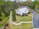 Aerial shot of a home featuring a metal roof, mature trees, and a well-manicured lawn in a quiet neighborhood at 161 Grace Cir, Acworth, GA 30102