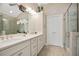 Bathroom featuring dual sinks, large cabinets, and a glass shower at 161 Grace Cir, Acworth, GA 30102