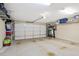 Spacious garage with storage shelves and an automatic door, offering ample space for vehicles and organization at 161 Grace Cir, Acworth, GA 30102
