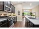 Modern kitchen with stainless steel appliances and a view into the breakfast nook at 161 Grace Cir, Acworth, GA 30102
