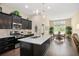 Spacious kitchen featuring stainless steel appliances, dark cabinets, and an island with granite countertops at 161 Grace Cir, Acworth, GA 30102