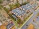 Aerial view of townhomes features manicured landscaping, private driveways, and well-maintained exteriors within a residential neighborhood at 19 Lindley Nw Ave, Marietta, GA 30064