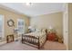 Bright bedroom with natural light, hardwood bed frame and shuttered windows at 19 Lindley Nw Ave, Marietta, GA 30064