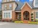 Inviting two-story home showcasing brick accents, manicured landscaping, and a welcoming arched entrance at 19 Lindley Nw Ave, Marietta, GA 30064