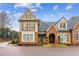 Attractive two-story house with brick and siding, complemented by well-kept landscaping and blue skies at 19 Lindley Nw Ave, Marietta, GA 30064