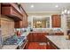 Gas range nestled among custom cabinets and granite countertops in this well-lit kitchen at 19 Lindley Nw Ave, Marietta, GA 30064