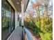 Private balcony with a view of a tree-lined yard at 220 Alcovy Terrace, Alpharetta, GA 30009