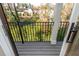 Exterior balcony view overlooking green space, trees, and the roofs of nearby houses at 220 Alcovy Terrace, Alpharetta, GA 30009