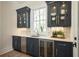 Stylish bar area with navy cabinets, marble counters, and stainless steel appliances at 220 Alcovy Terrace, Alpharetta, GA 30009