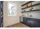 Bar area with navy cabinets, open shelving, white countertops, and a view of the neighborhood at 220 Alcovy Terrace, Alpharetta, GA 30009