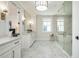 Bright bathroom with marble floors, double sinks, and glass shower at 220 Alcovy Terrace, Alpharetta, GA 30009