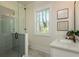 Bathroom with a sleek glass-enclosed shower and stylish vanity with natural lighting at 220 Alcovy Terrace, Alpharetta, GA 30009