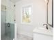 Bright bathroom with a glass enclosed shower, vanity, marble countertop, and black fixtures at 220 Alcovy Terrace, Alpharetta, GA 30009