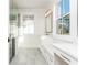 Bright bathroom with a glass enclosed shower, vanity, marble countertop, and a large window at 220 Alcovy Terrace, Alpharetta, GA 30009