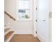 Light-filled entryway features beautiful hardwood stairs, a modern railing, and a window at 220 Alcovy Terrace, Alpharetta, GA 30009