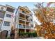 Stunning three-story exterior featuring multiple balconies, stone accents, and professional landscaping at 220 Alcovy Terrace, Alpharetta, GA 30009