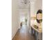 Entryway with hardwood floors and hallway table with lamps and mirrors at 220 Alcovy Terrace, Alpharetta, GA 30009