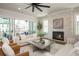 Elegant living room with a stone fireplace and sliding doors to the outdoor patio at 220 Alcovy Terrace, Alpharetta, GA 30009