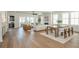 Open-concept living and dining area with hardwood floors and natural light, flowing to an outdoor balcony at 220 Alcovy Terrace, Alpharetta, GA 30009
