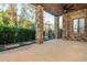 Covered patio with stone columns, a ceiling fan, and a view of the private yard at 220 Alcovy Terrace, Alpharetta, GA 30009