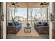 Cozy covered patio with comfortable seating and an outdoor ceiling fan at 220 Alcovy Terrace, Alpharetta, GA 30009
