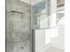 Modern glass enclosed shower with a tiled floor and window providing natural light at 220 Alcovy Terrace, Alpharetta, GA 30009