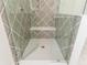Modern shower with decorative tile, a glass enclosure, and built-in bench at 220 Alcovy Terrace, Alpharetta, GA 30009