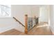 Elegant staircase with hardwood floors and decorative metal railing at 220 Alcovy Terrace, Alpharetta, GA 30009
