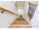 Well-lit staircase featuring hardwood treads and decorative iron railing at 220 Alcovy Terrace, Alpharetta, GA 30009