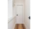 Hallway leading to walk-in closet with custom shelves and modern door at 220 Alcovy Terrace, Alpharetta, GA 30009