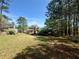 Spacious, private backyard with mature trees surrounding the home, creating a serene and secluded outdoor space at 560 Hunt River Way, Suwanee, GA 30024
