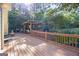 Spacious wooden deck overlooking a stone fire pit and lush landscaping at 560 Hunt River Way, Suwanee, GA 30024