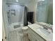 Updated bathroom showcasing a tiled shower/tub, granite countertops, and modern fixtures at 560 Hunt River Way, Suwanee, GA 30024