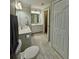 Bathroom featuring double vanity, granite countertop, wood-look tile flooring and a walk-in closet at 560 Hunt River Way, Suwanee, GA 30024